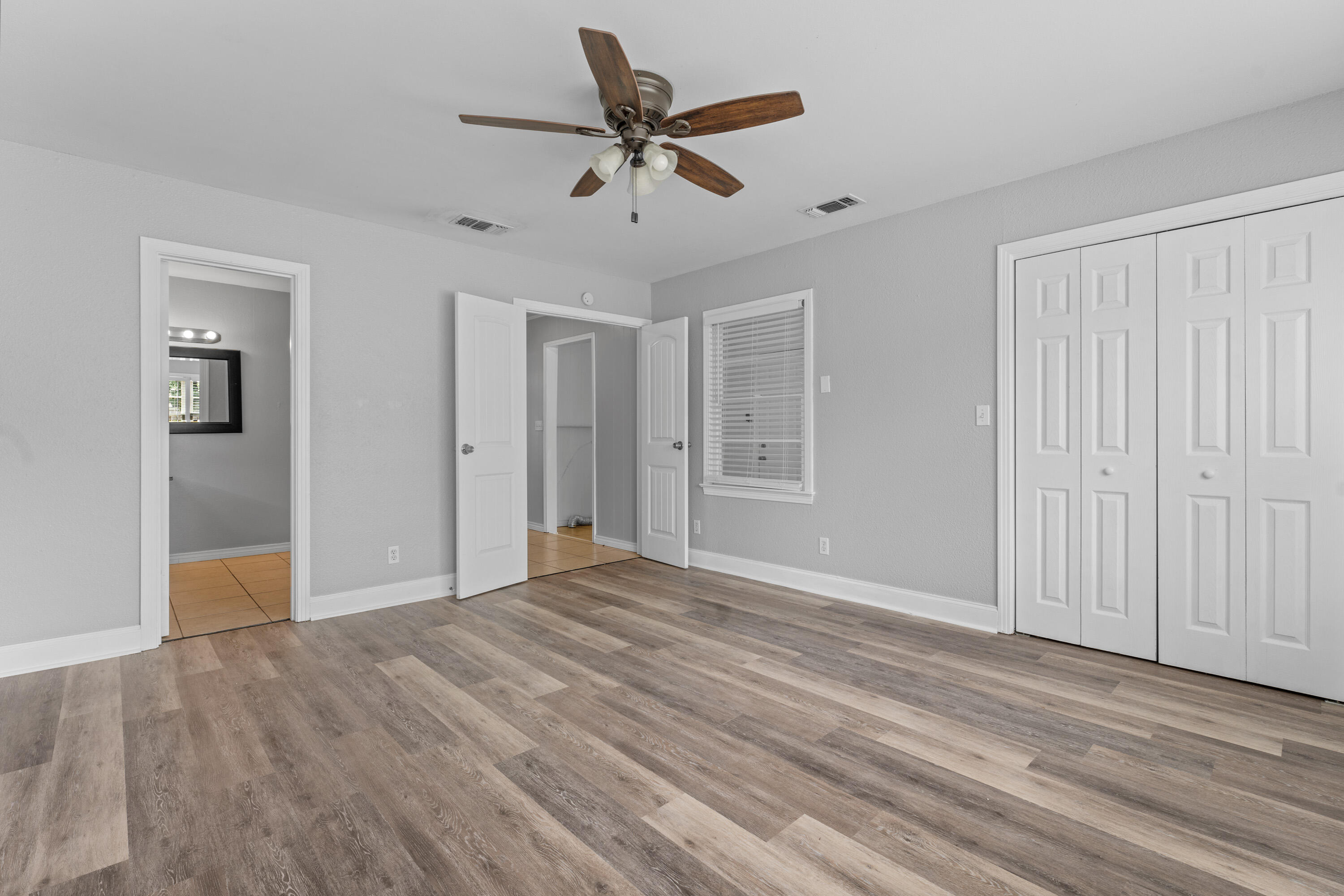 3313 26th Street Lubbock, TX 79410 - Photo 16 of 21 a view of empty room with wooden floor and ceiling fan