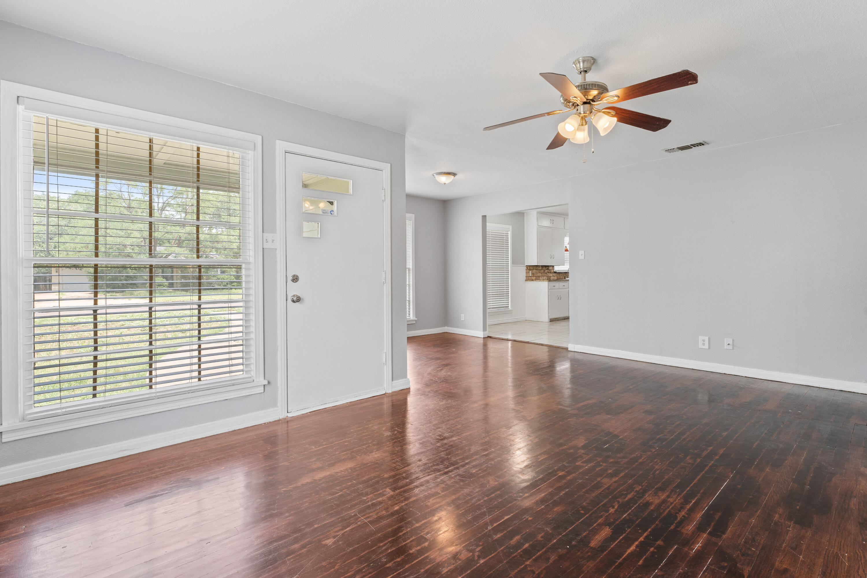 3313 26th Street Lubbock, TX 79410 - Photo 4 of 21 a view of empty room with wooden floor and fan