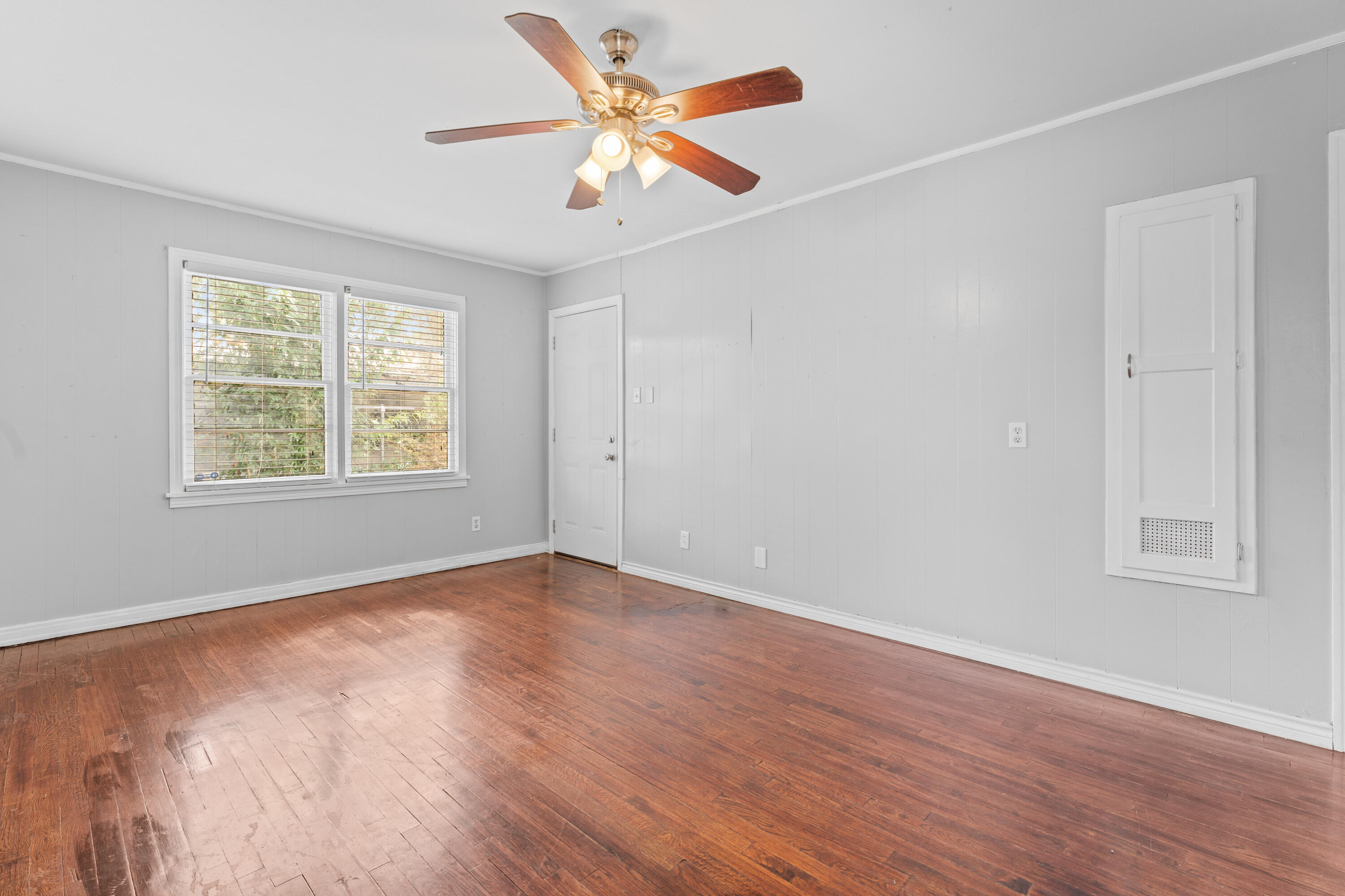 3313 26th Street Lubbock, TX 79410 - Photo 8 of 21 wooden floor in an empty room with a window