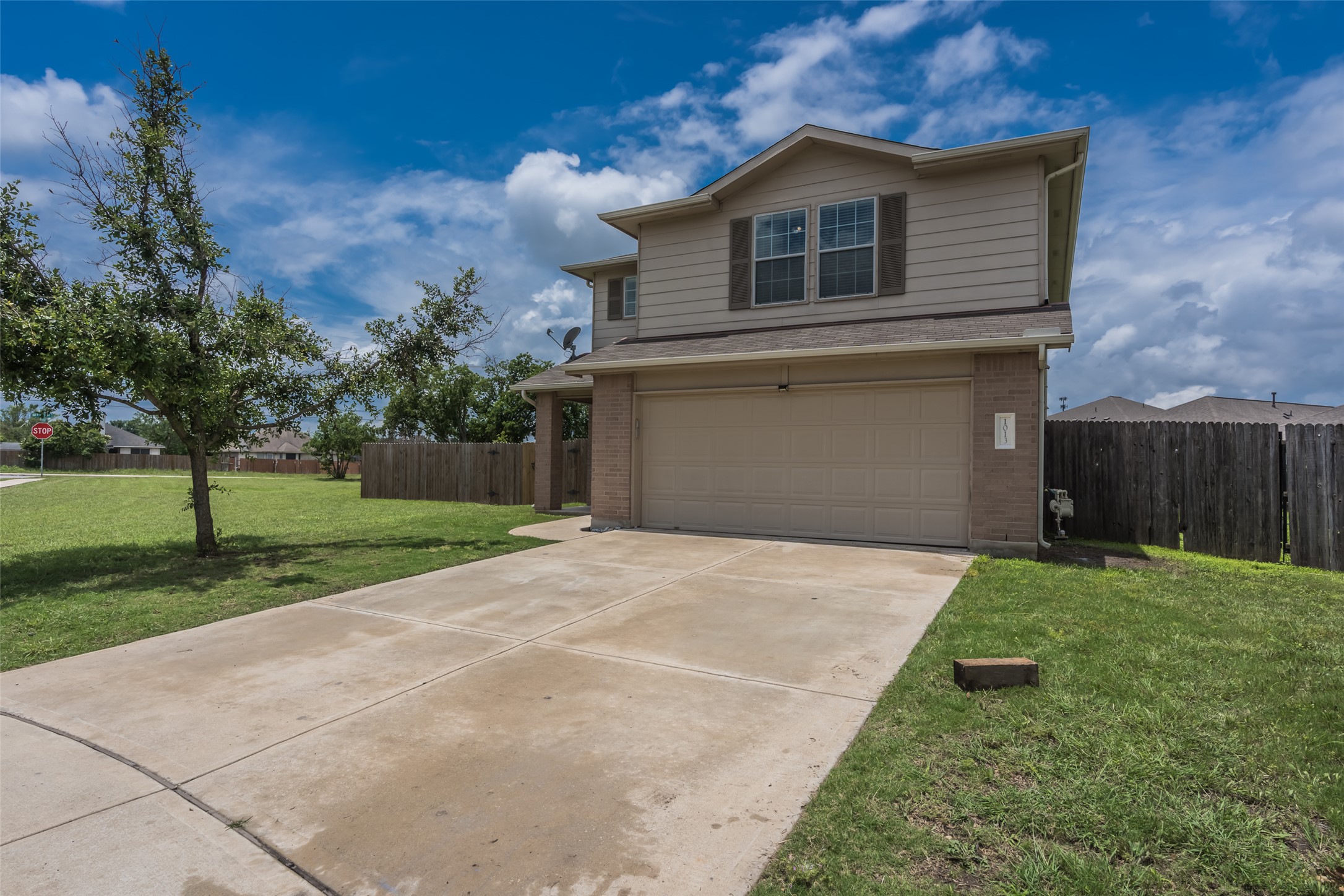 1013 Ranchero Road Leander, TX 78641 - Photo 2 of 30 A spacious concrete driveway leads directly to the attached two-car garage of this multi-level home.