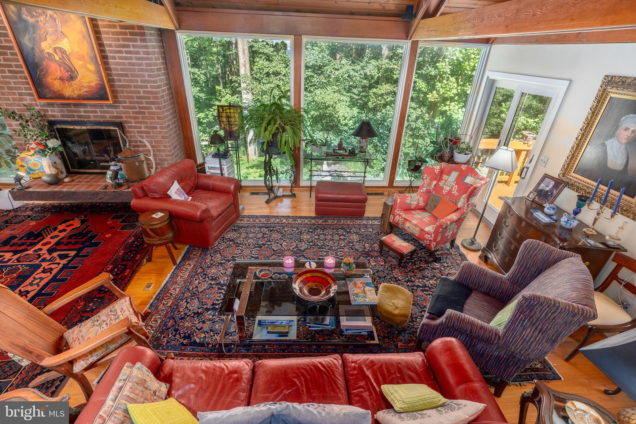 11301 Fieldstone Lane Reston, VA 20191 - Photo 10 of 46 a living room with furniture a fireplace and floor to ceiling windows