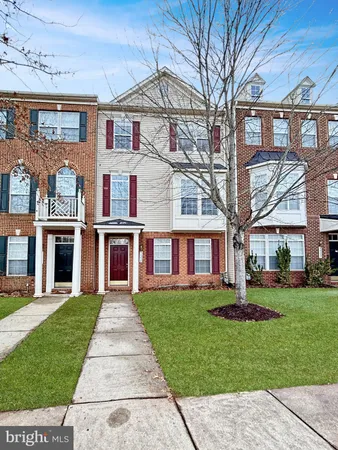 front view of a brick house with a yard