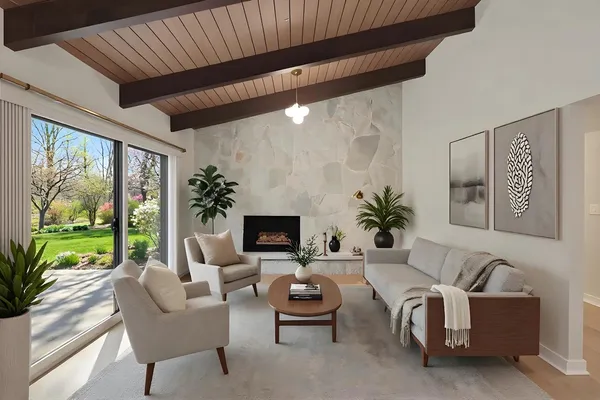 a living room with furniture and a floor to ceiling window