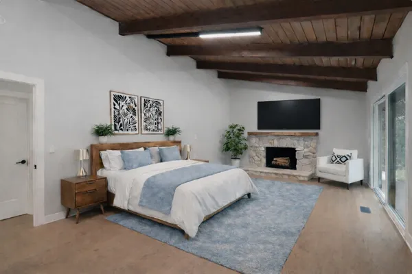 a spacious bedroom with a bed and a fireplace