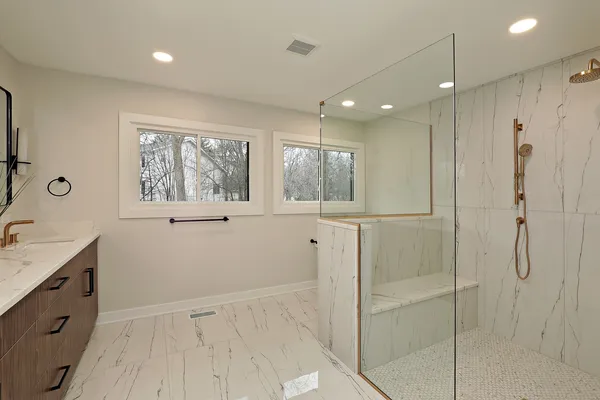 a bathroom with a shower sink and mirror