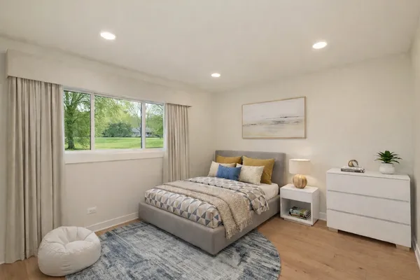 a bedroom with a bed and a window