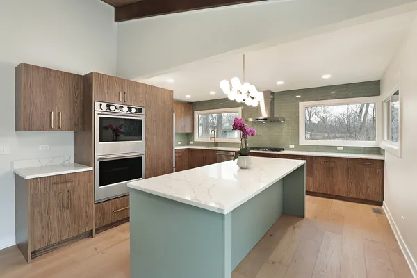 a kitchen with stainless steel appliances a stove top oven