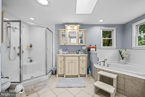 a spacious bathroom with a shower sink and mirror
