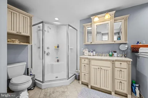 a bathroom with a granite countertop sink toilet and shower
