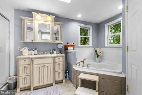 a bath room with a sink and a window