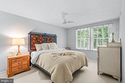 a bed room with a bed and a window