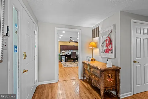 a view of living room with furniture and wooden floor