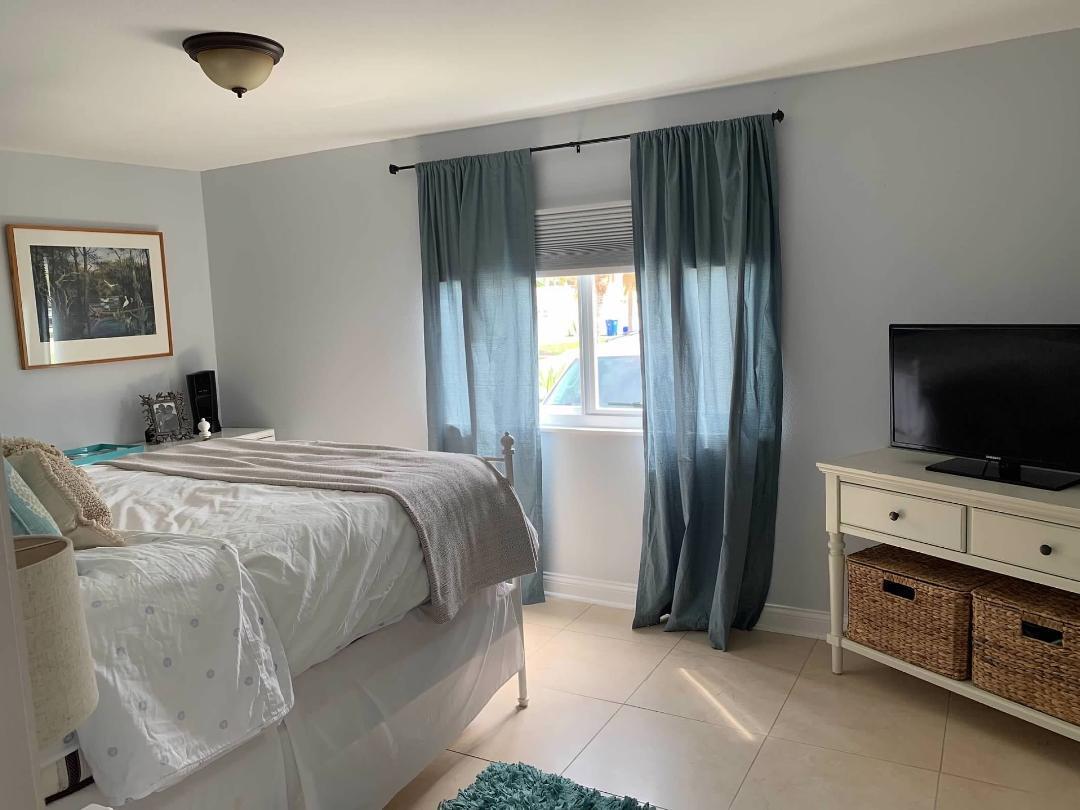 46 Ocean Drive Key Largo, FL 33037 - Photo 11 of 15 a bedroom with a bed and a flat screen tv