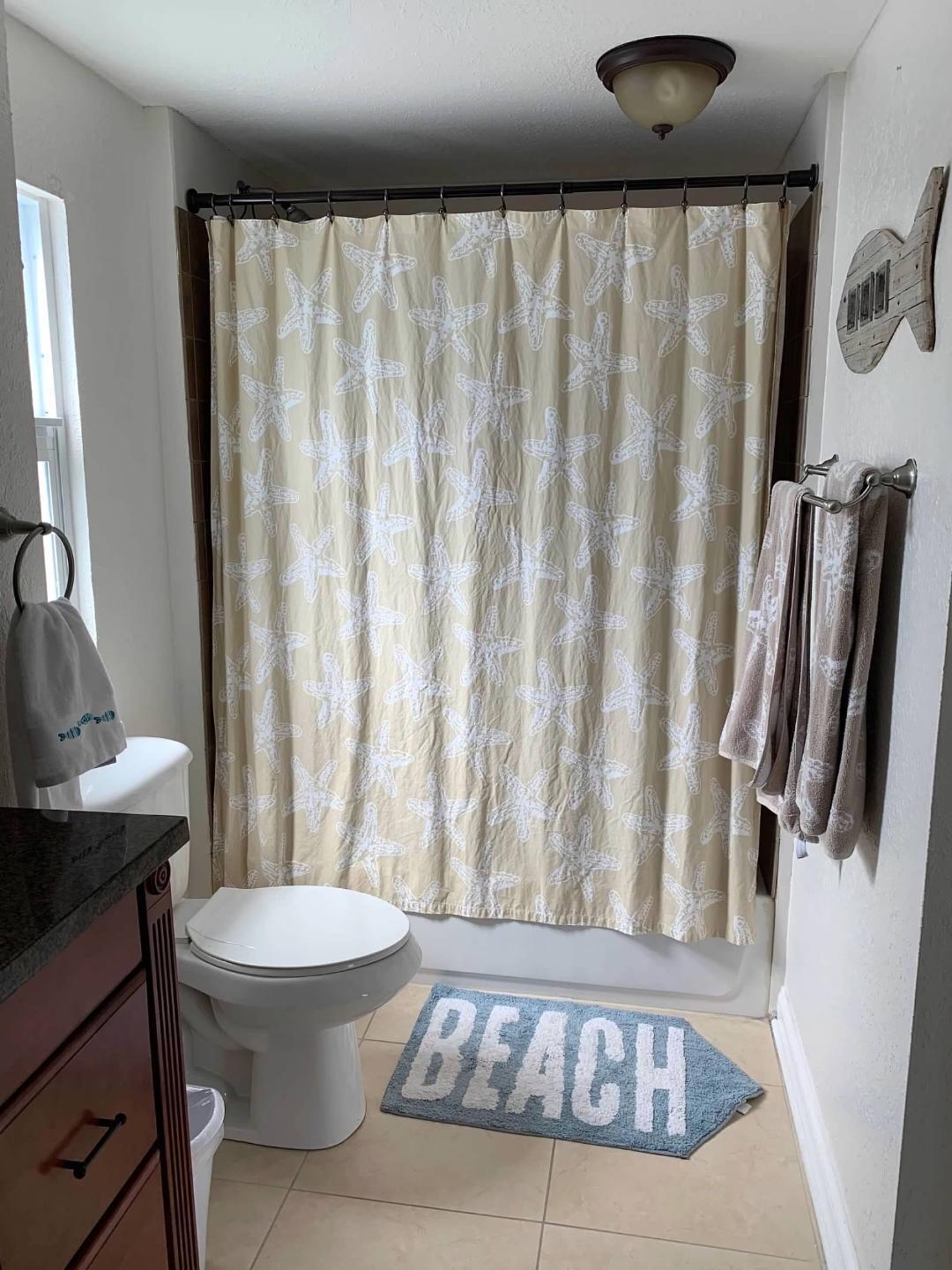 46 Ocean Drive Key Largo, FL 33037 - Photo 12 of 15 a bathroom with a toilet a sink and curtain