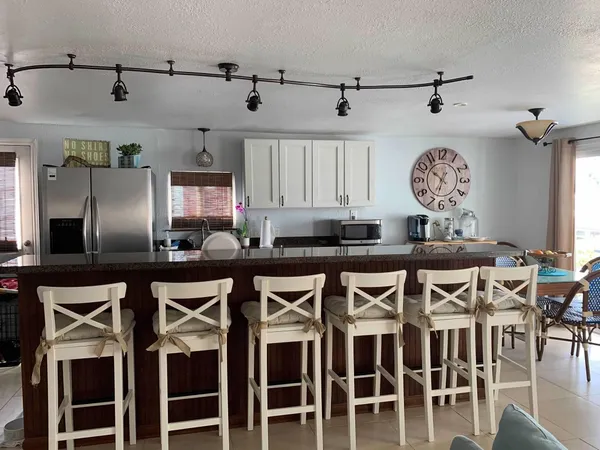 a dining table with chairs and wooden floor