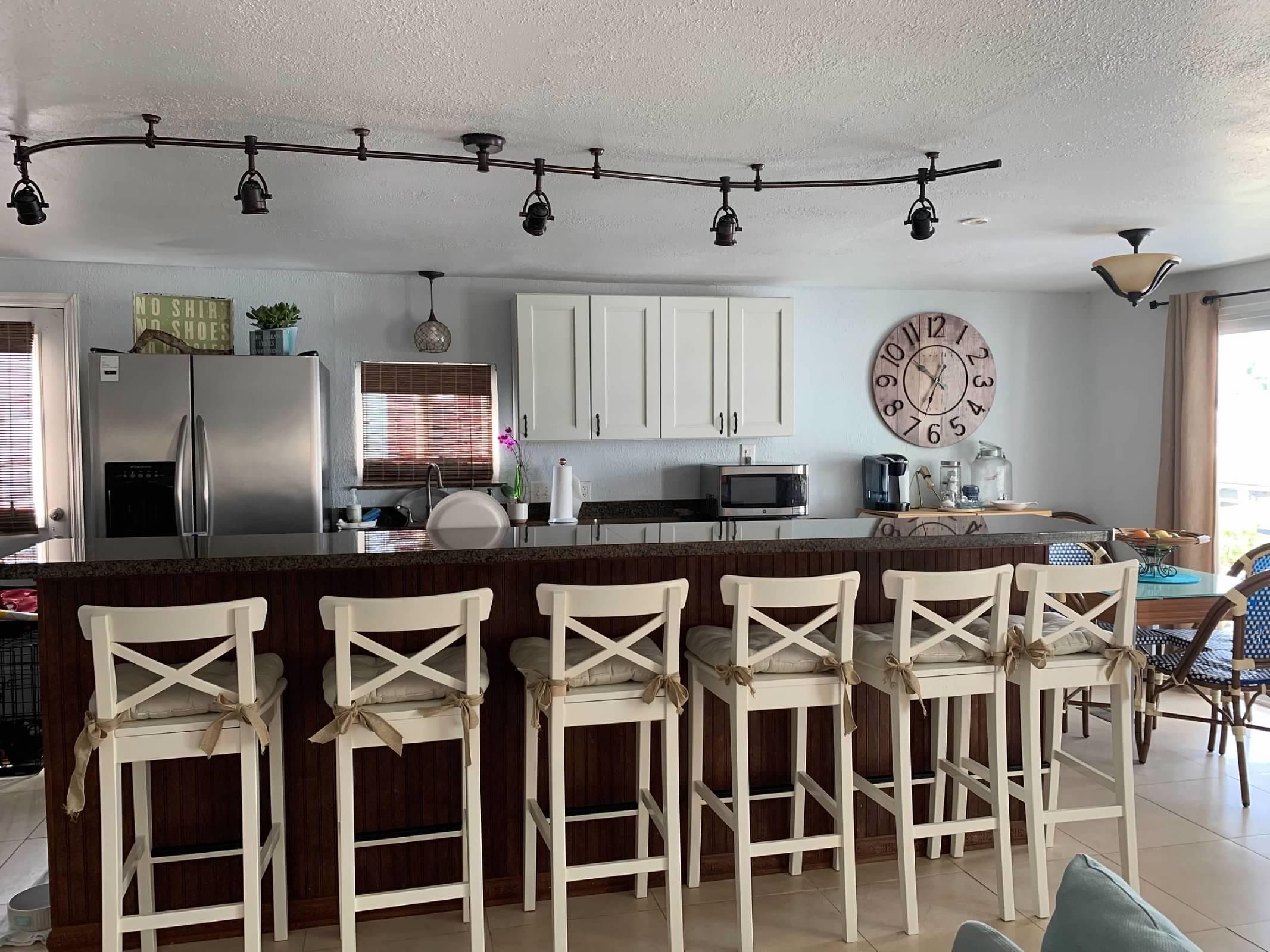 46 Ocean Drive Key Largo, FL 33037 - Photo 2 of 15 a dining table with chairs and wooden floor