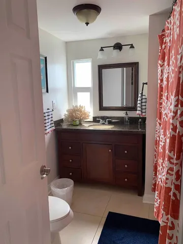 a bathroom with a sink vanity and mirror