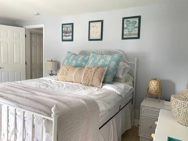 a bed sitting in a bedroom and chair