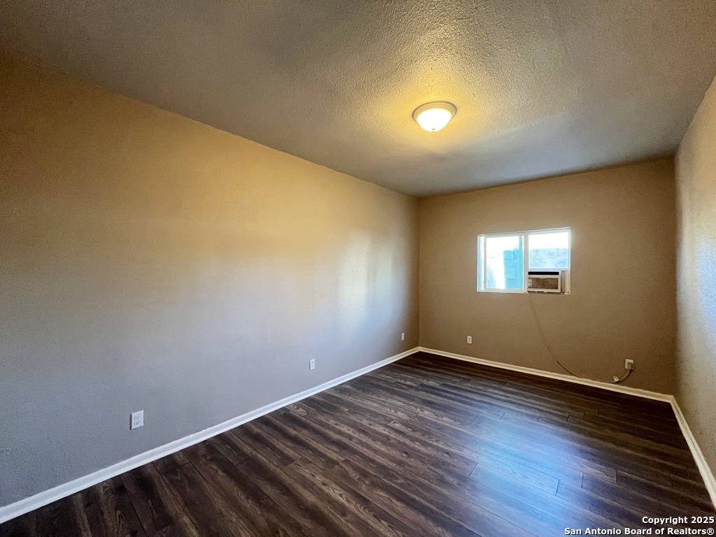378 East Petaluma Boulevard, Unit B San Antonio, TX 78221 - Photo 13 of 25 a view of room with wooden floor and windows