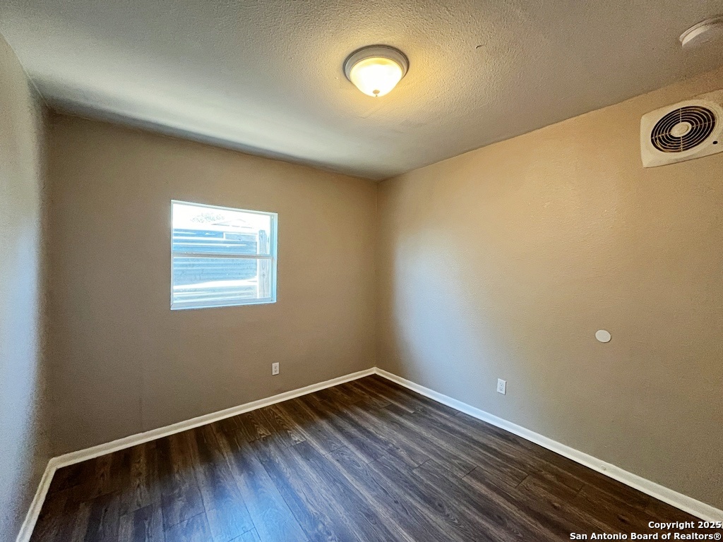 378 East Petaluma Boulevard, Unit B San Antonio, TX 78221 - Photo 18 of 25 an empty room with wooden floor and windows