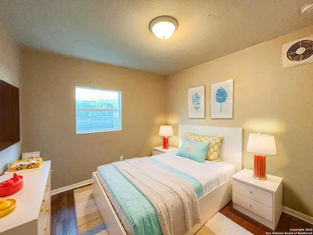 a bedroom with a bed and a lamp on table