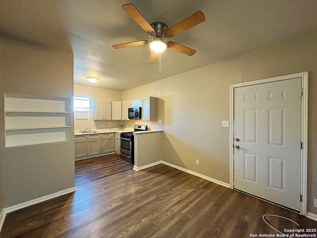 378 East Petaluma Boulevard, Unit B San Antonio, TX 78221 - Photo 8 of 25 a kitchen with a refrigerator and white cabinets