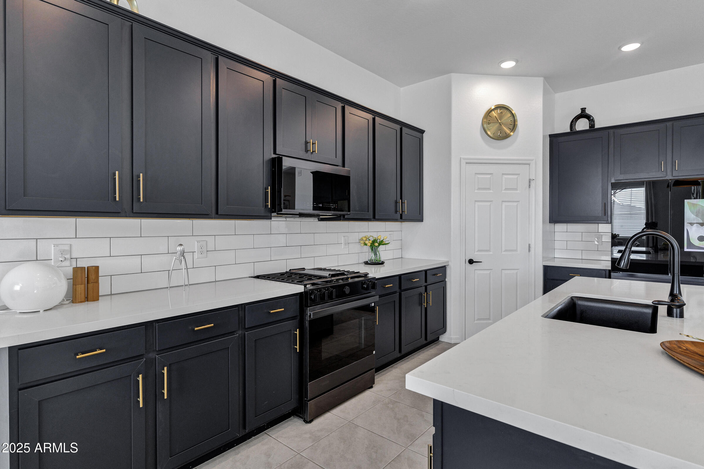 23025 East Happy Road Queen Creek, AZ 85142 - Photo 11 of 31 a kitchen with granite countertop a sink dishwasher stove and cabinets