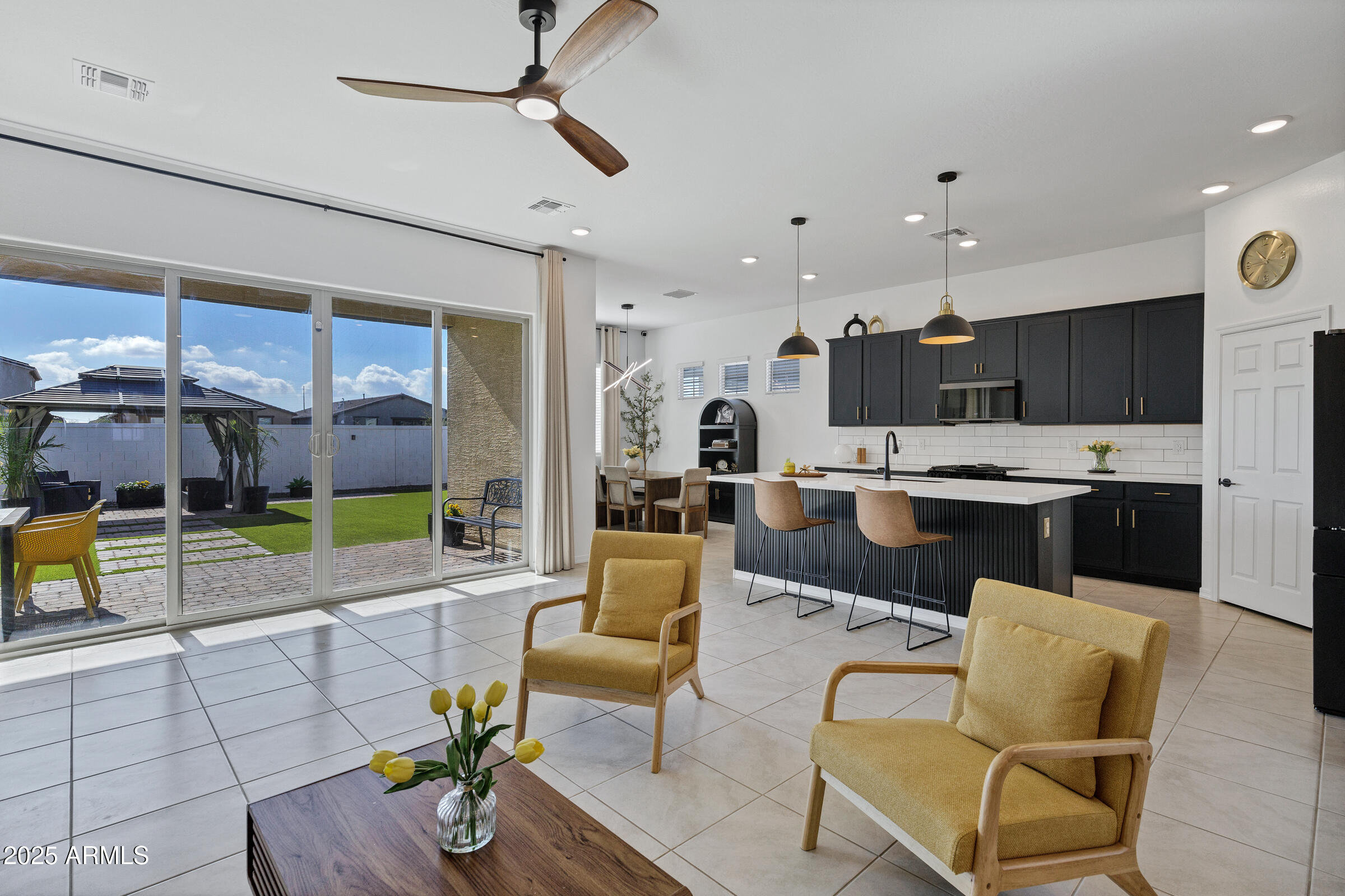 23025 East Happy Road Queen Creek, AZ 85142 - Photo 9 of 31 a living room with stainless steel appliances kitchen island granite countertop furniture and a view of kitchen