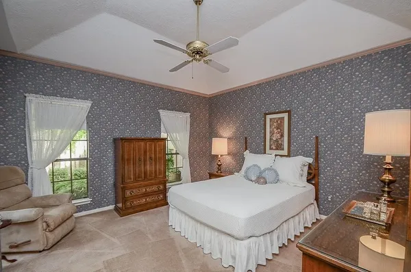 a bedroom with a bed and a couch