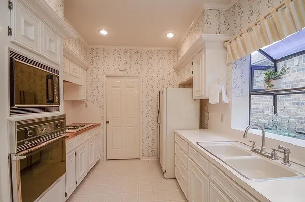 a kitchen with stainless steel appliances a stove sink and refrigerator