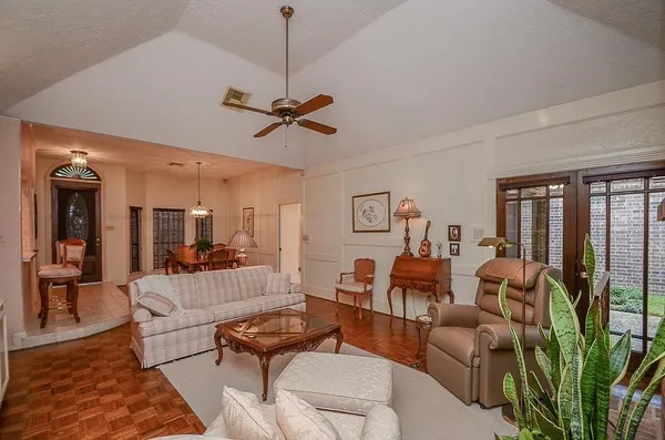a living room with furniture ceiling fan and a rug