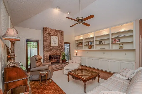 a living room with furniture a rug and a fireplace