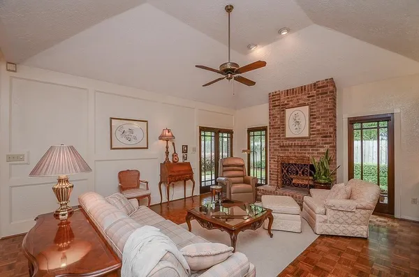 a living room with furniture ceiling fan and a fireplace