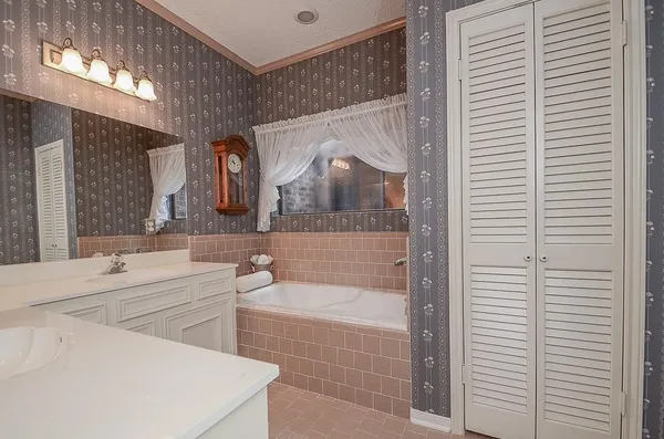 a bathroom with a sink a mirror and bathtub