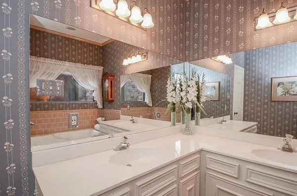 a bathroom with a double vanity sink and a mirror