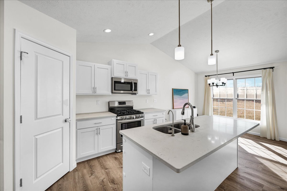259 Cassidy Road Normal, IL 61761 - Photo 11 of 28 a kitchen with kitchen island white cabinets and refrigerator