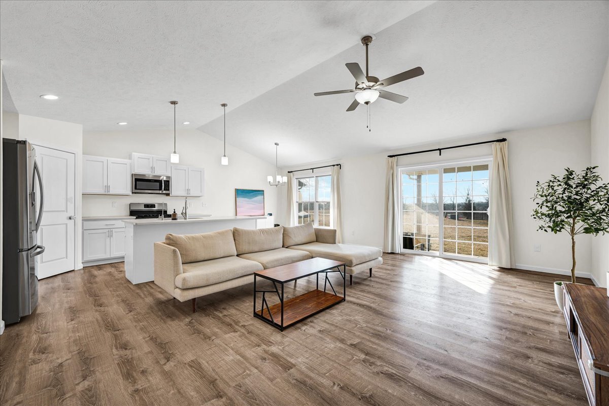 259 Cassidy Road Normal, IL 61761 - Photo 5 of 28 a living room with furniture and a large window with kitchen view