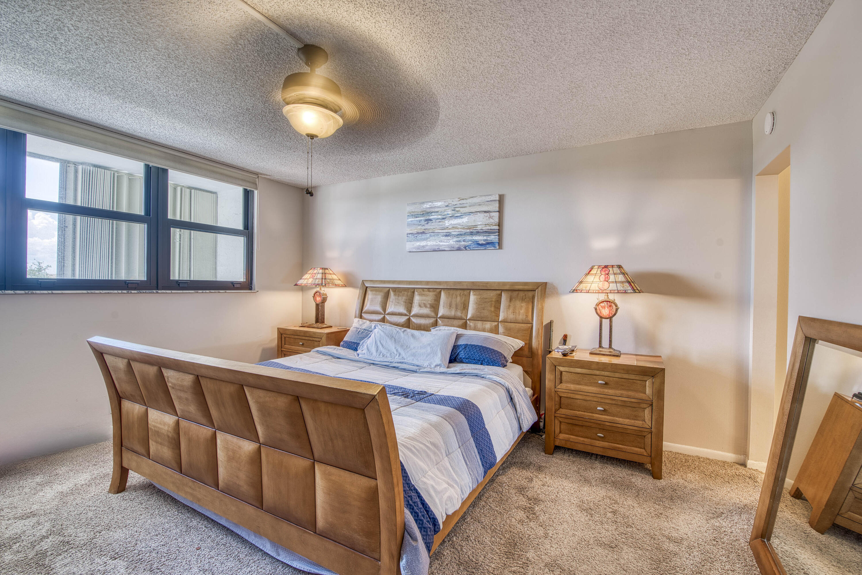 336 Golfview Road, Unit 518 North Palm Beach, FL 33408 - Photo 13 of 31 a bedroom with a bed and a lamp with window