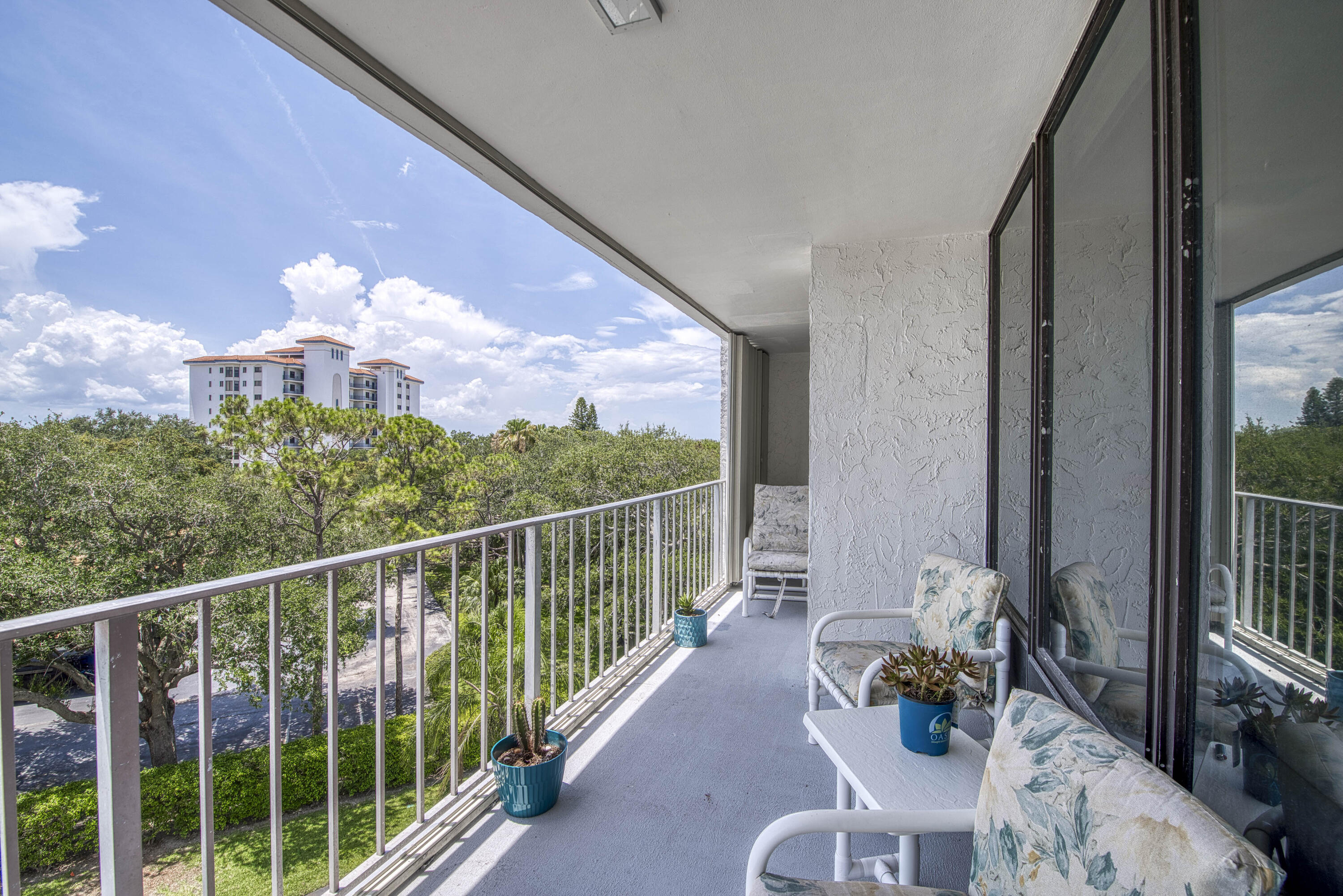 336 Golfview Road, Unit 518 North Palm Beach, FL 33408 - Photo 5 of 31 a view of a balcony with dining table and chairs