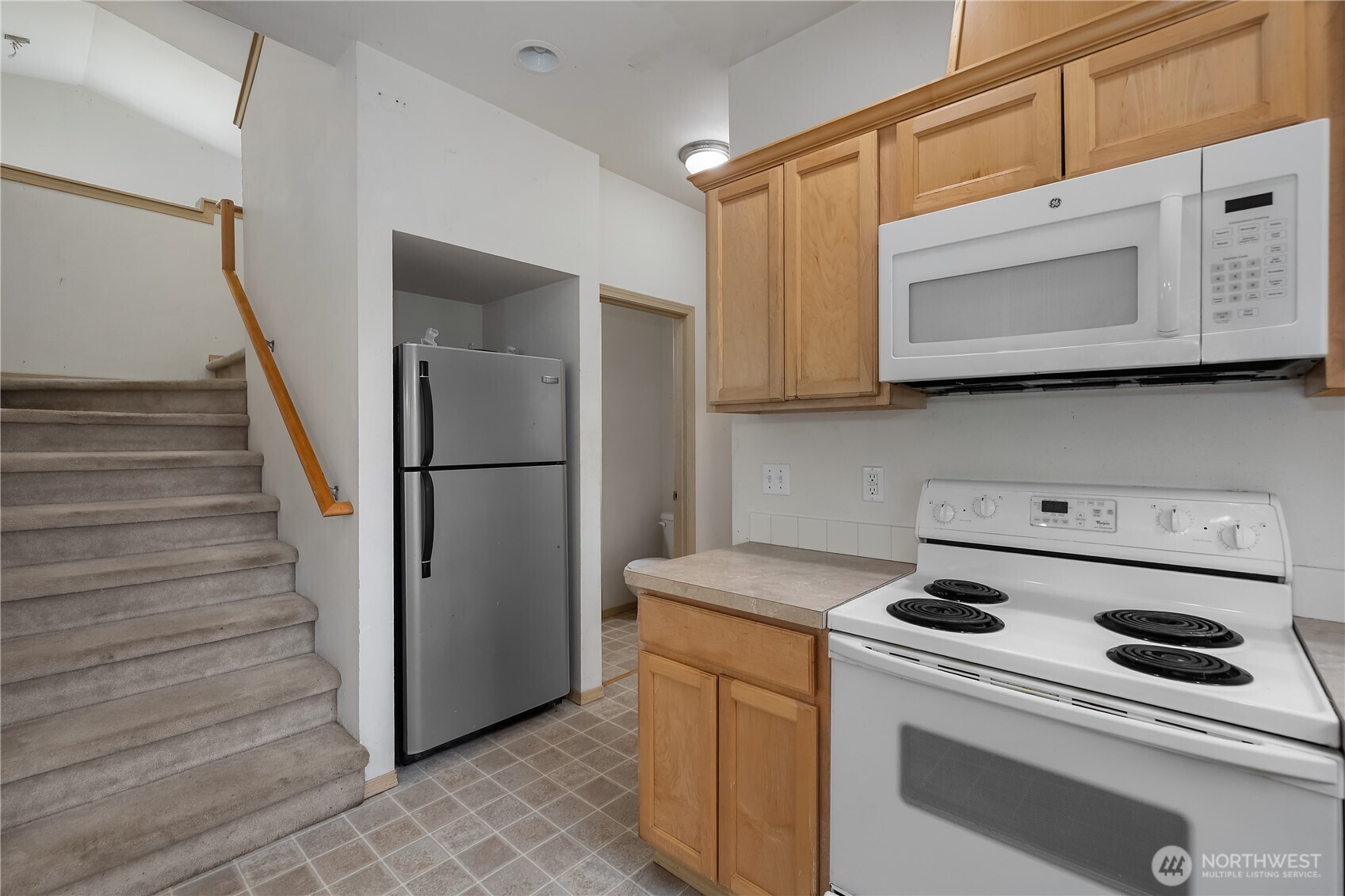 4604 20th Way Northeast Olympia, WA 98516 - Photo 11 of 34 a kitchen with white cabinets and white appliances