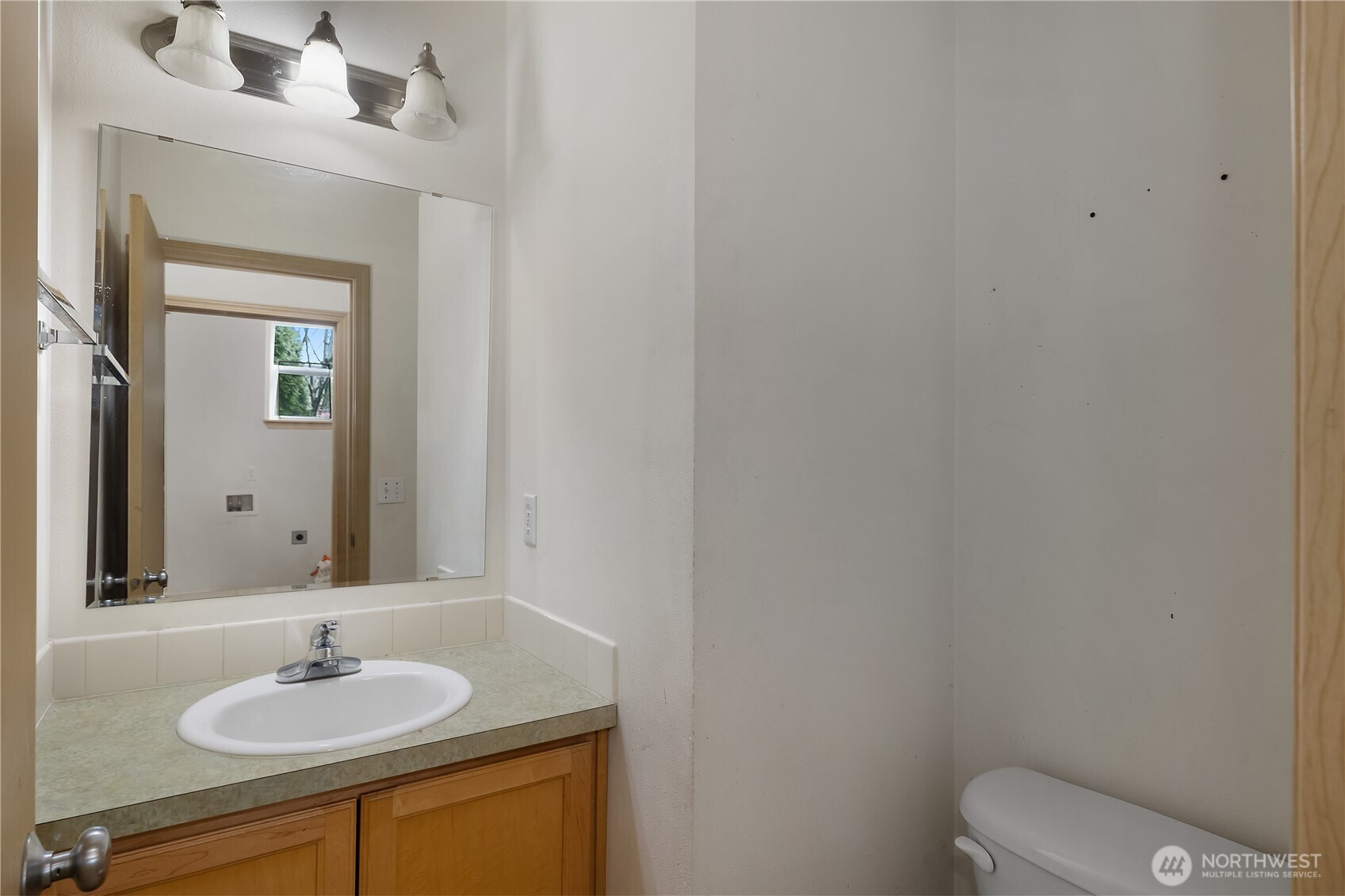 4604 20th Way Northeast Olympia, WA 98516 - Photo 12 of 34 a bathroom with a granite countertop sink and a mirror