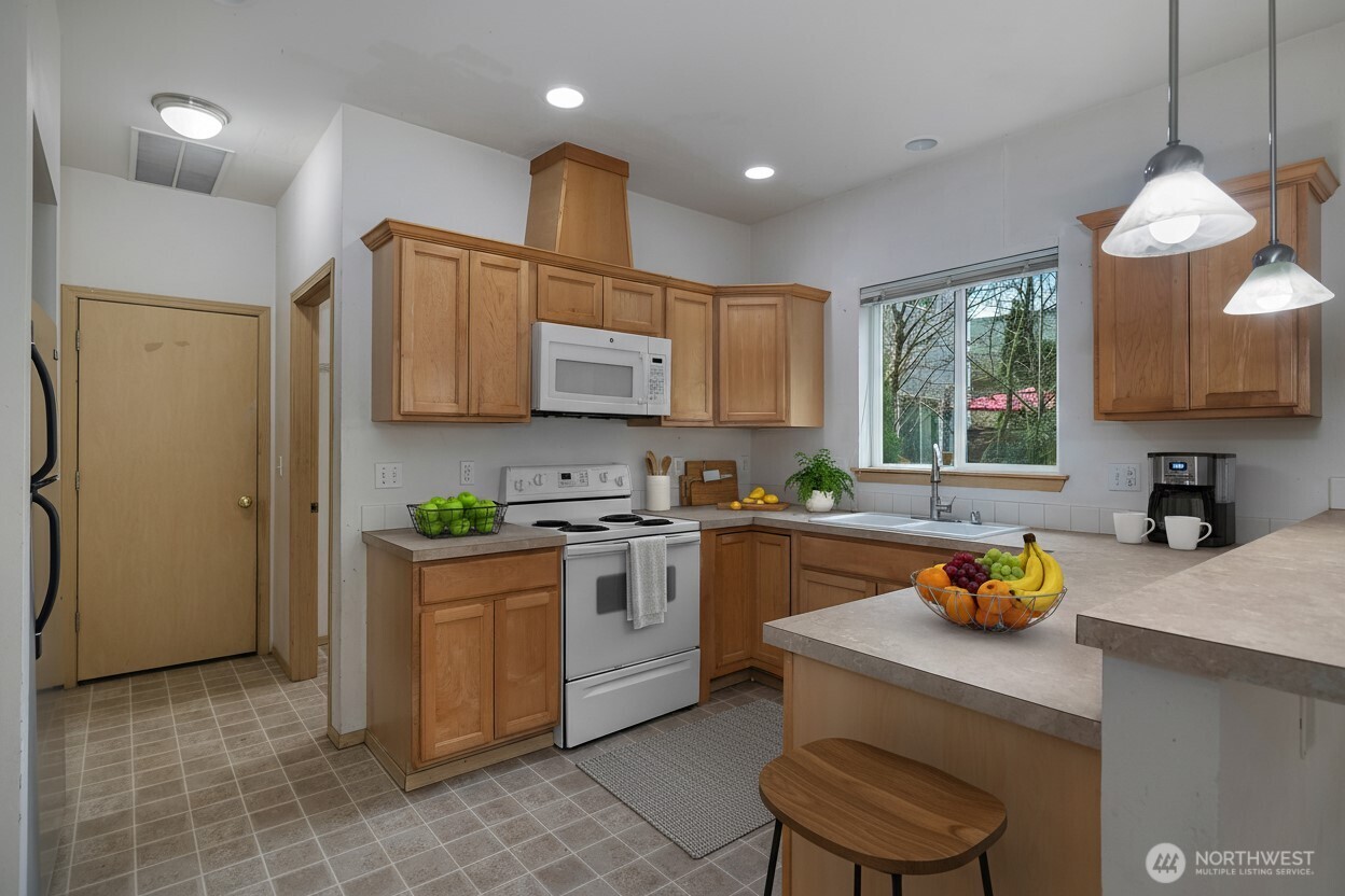 4604 20th Way Northeast Olympia, WA 98516 - Photo 7 of 34 a kitchen with stainless steel appliances granite countertop a sink refrigerator stove and microwave