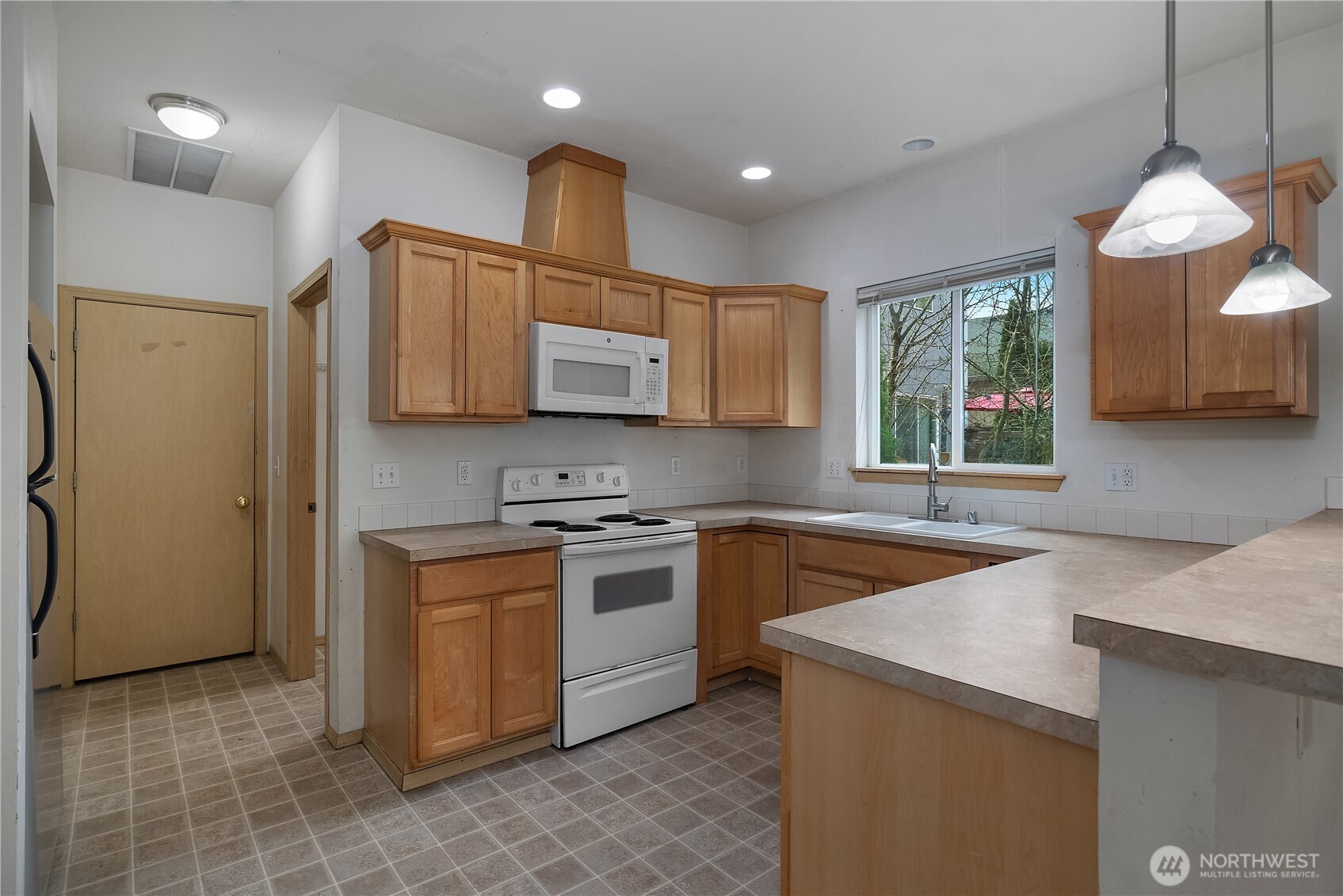 4604 20th Way Northeast Olympia, WA 98516 - Photo 8 of 34 a kitchen with stainless steel appliances granite countertop a sink stove and refrigerator