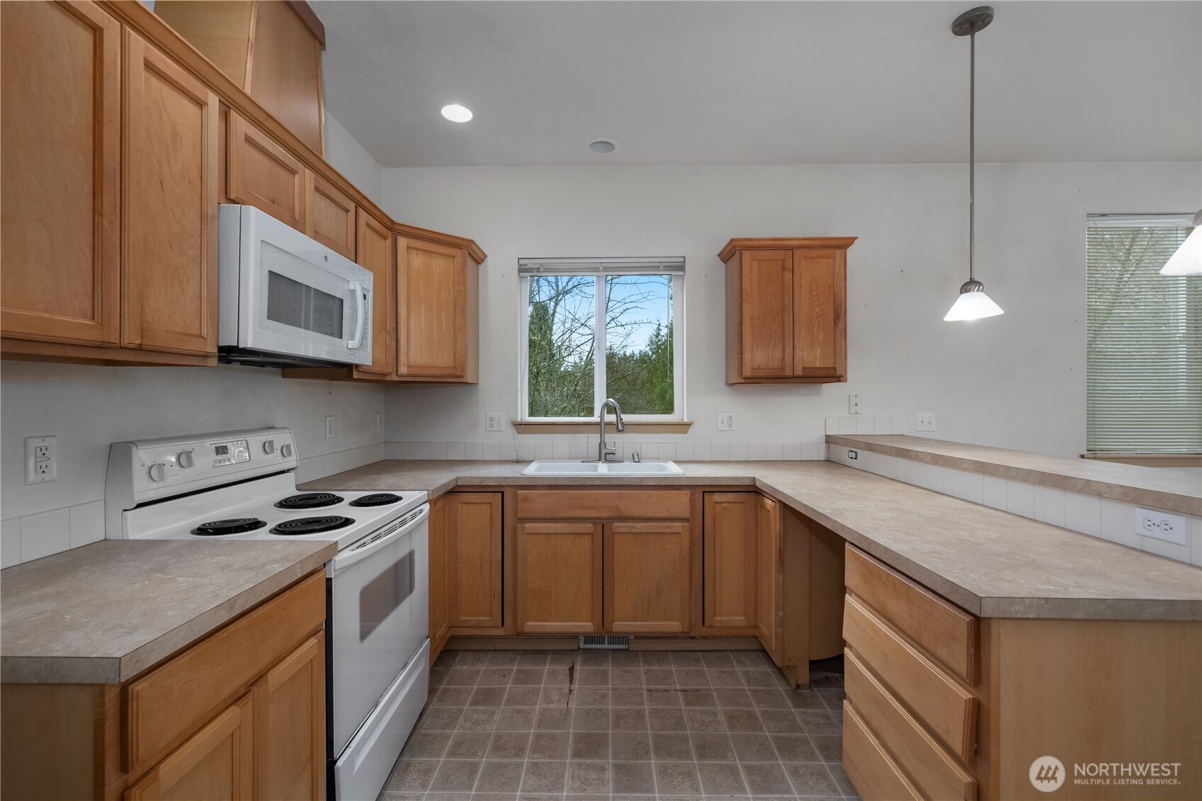4604 20th Way Northeast Olympia, WA 98516 - Photo 9 of 34 a kitchen with a sink stove top oven and cabinets