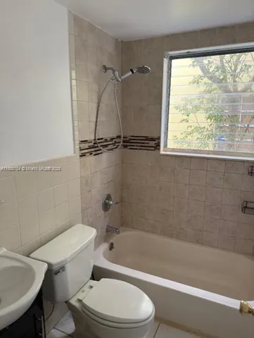 a bathroom with a toilet a sink and a bathtub