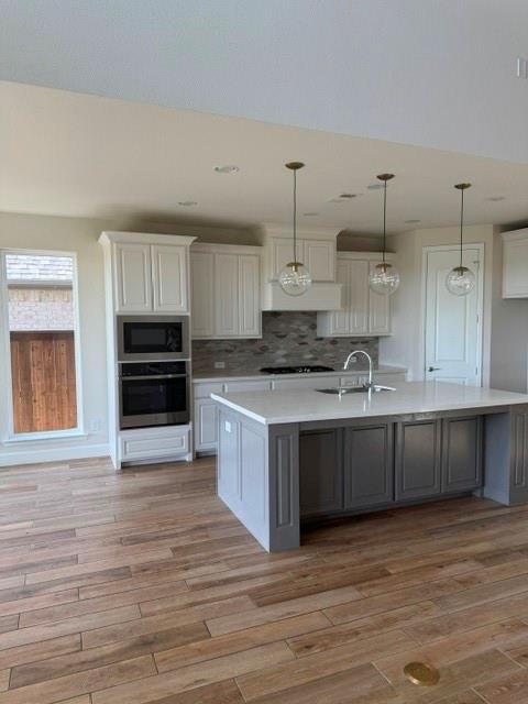 1917 Halkin Road Celina, TX 75009 - Photo 22 of 24 a large kitchen with cabinets wooden floor and stainless steel appliances