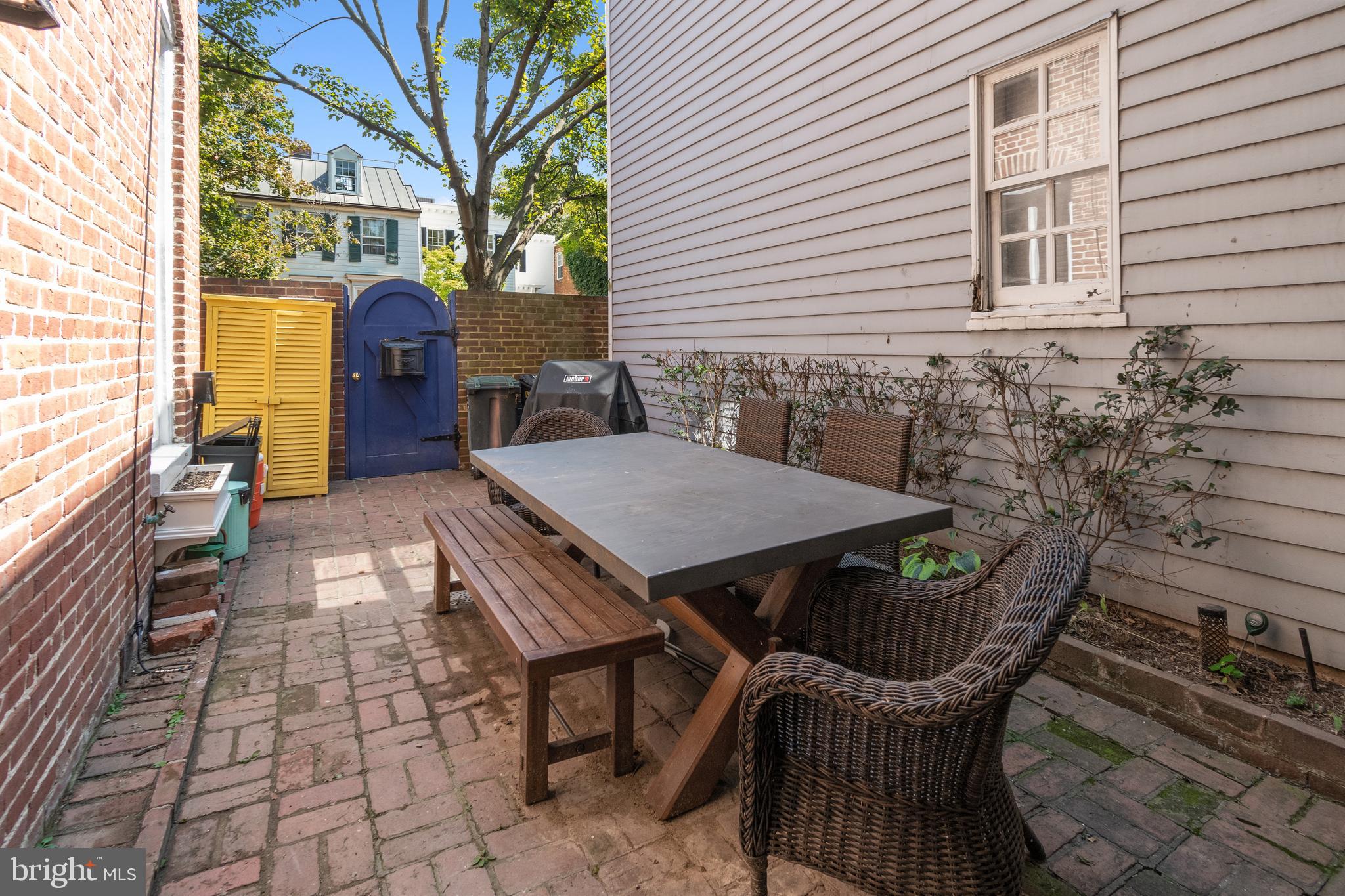 1244 34th Street Northwest Washington, DC 20007 - Photo 23 of 26 a view of a patio with table and chairs with wooden floor and fence