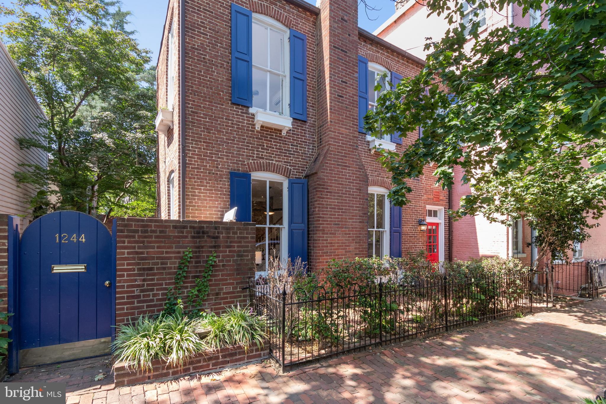 1244 34th Street Northwest Washington, DC 20007 - Photo 4 of 26 a front view of a house with a garden