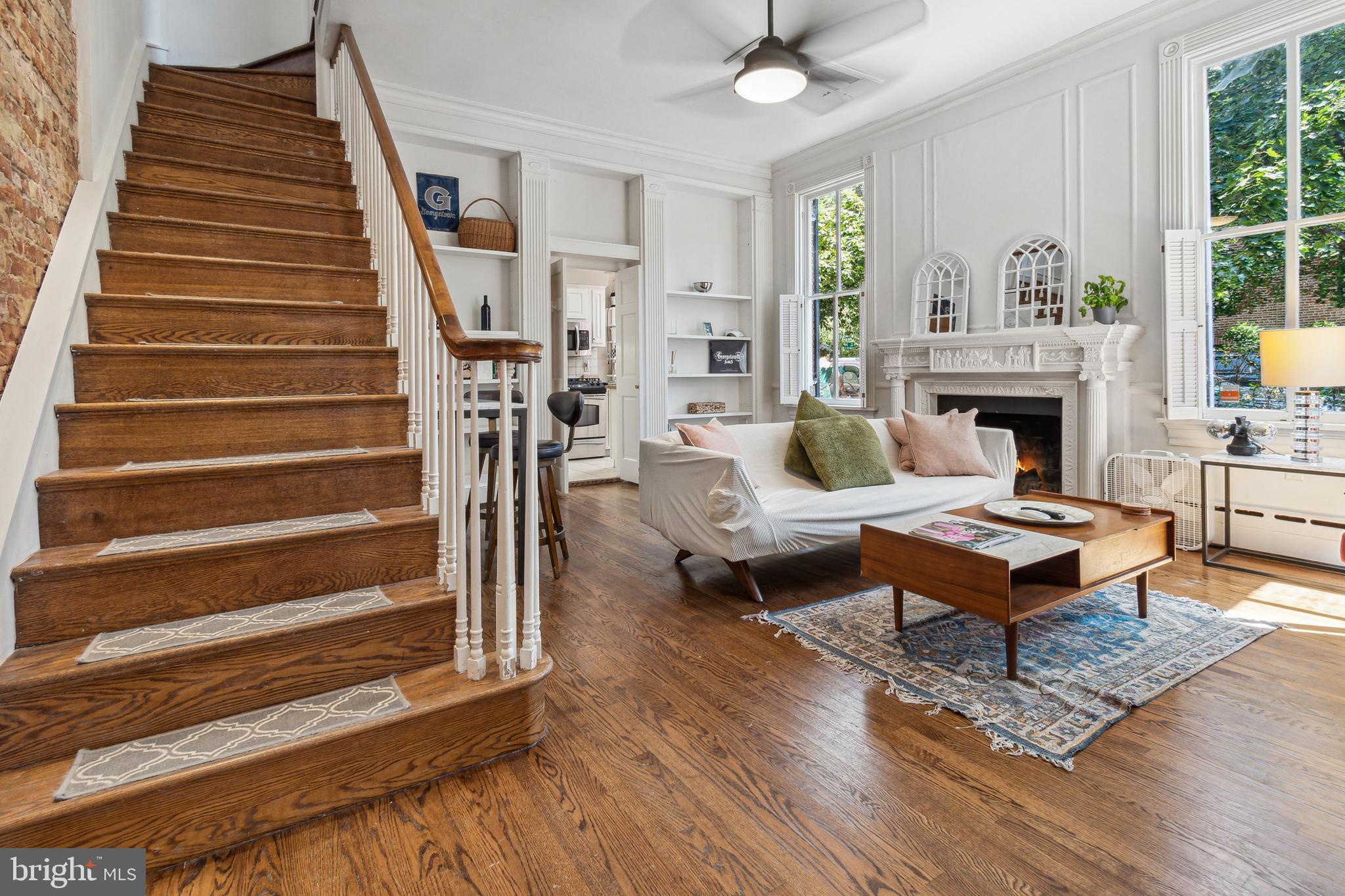1244 34th Street Northwest Washington, DC 20007 - Photo 7 of 26 a living room with furniture a fireplace and a chandelier