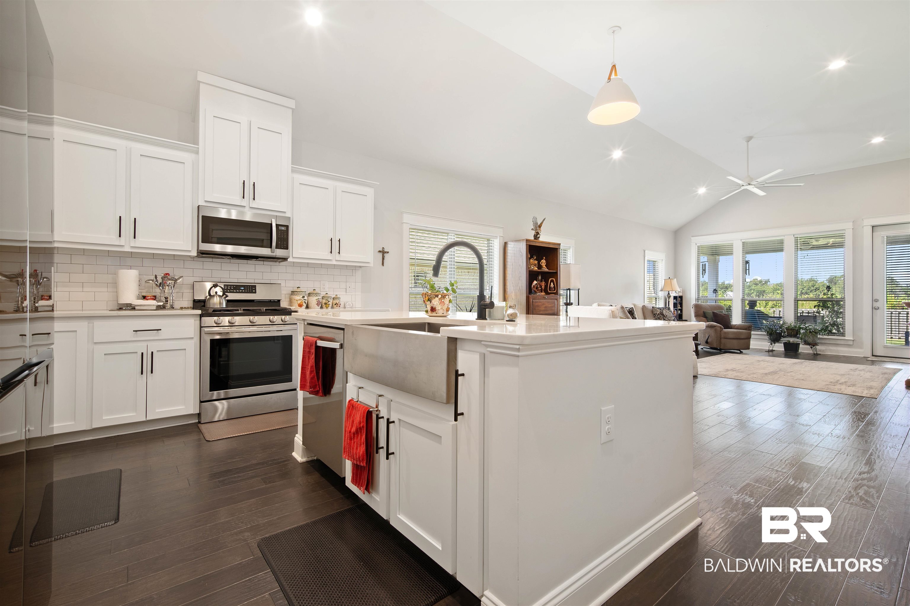 969 Charleston Loop Fairhope, AL 36532 - Photo 10 of 30 Kitchen featuring dark hardwood / wood-style flooring, white cabinetry, a healthy amount of sunlight, and stainless steel appliances